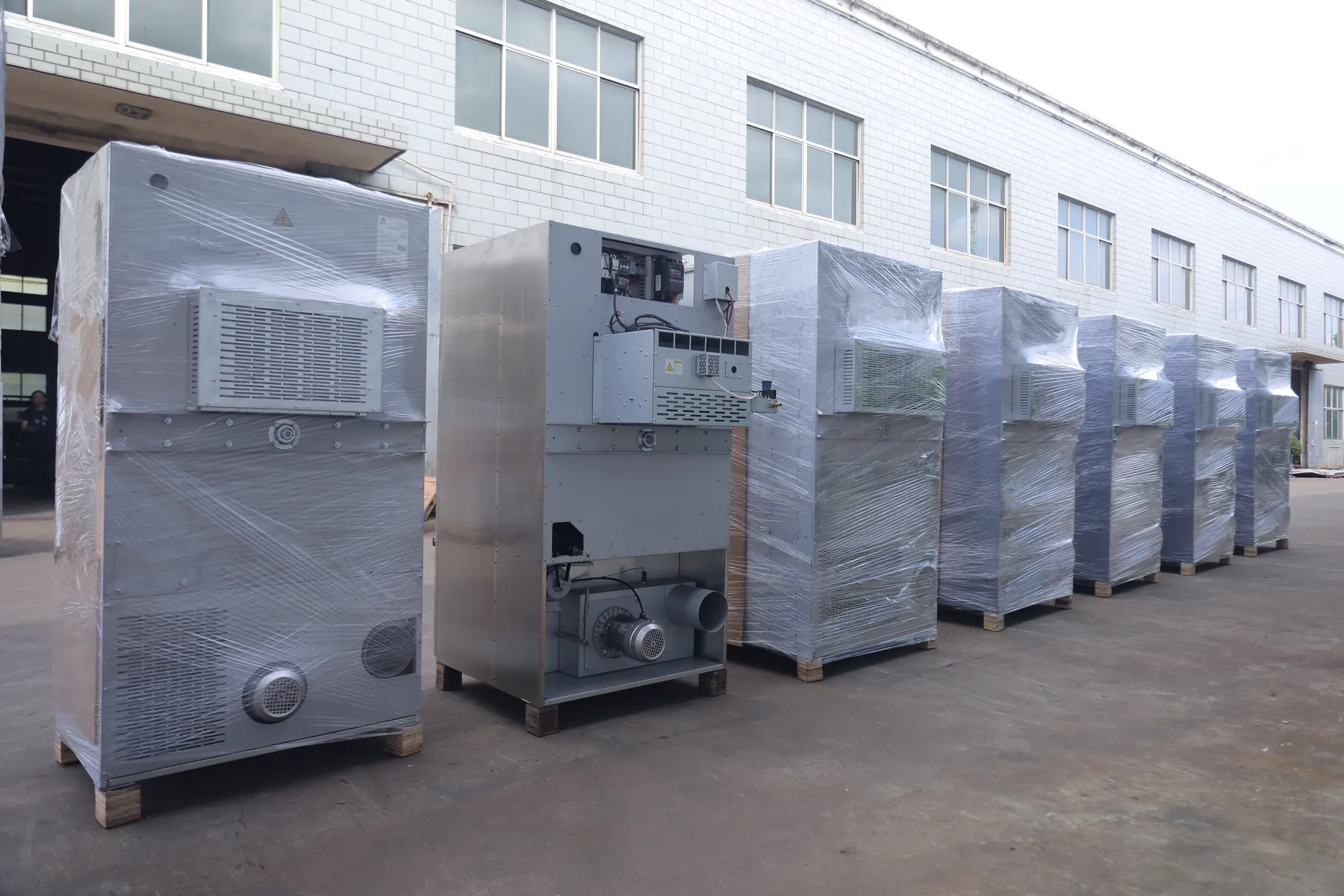Row of wrapped Laundry Aide machines ready for shipment